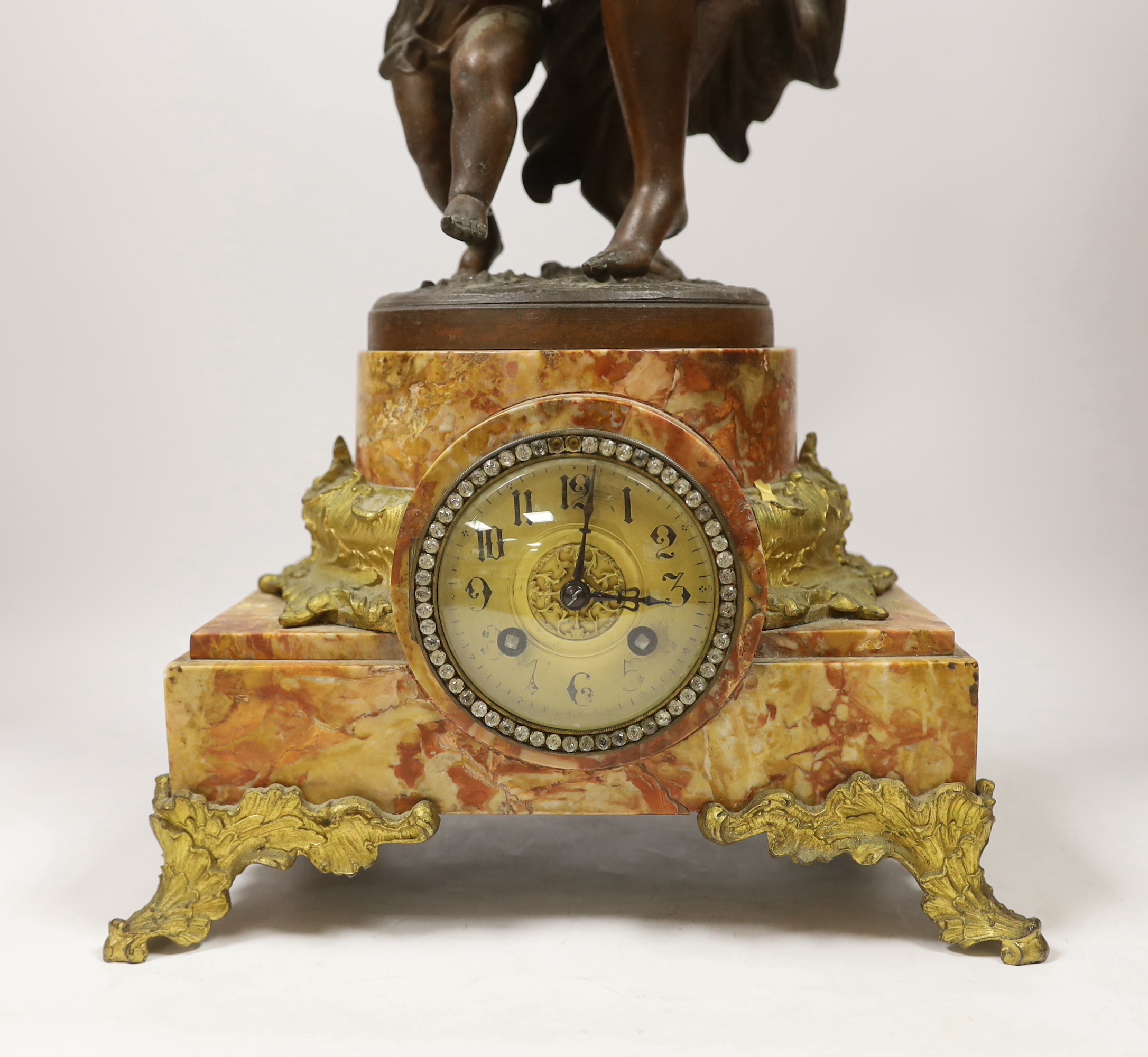 A large bronzed spelter dancer and putti table clock on marble base, 70cm high